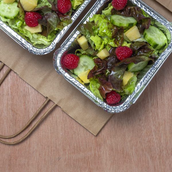 Healthy vegan Take away salad in aluminum container or food delivery.